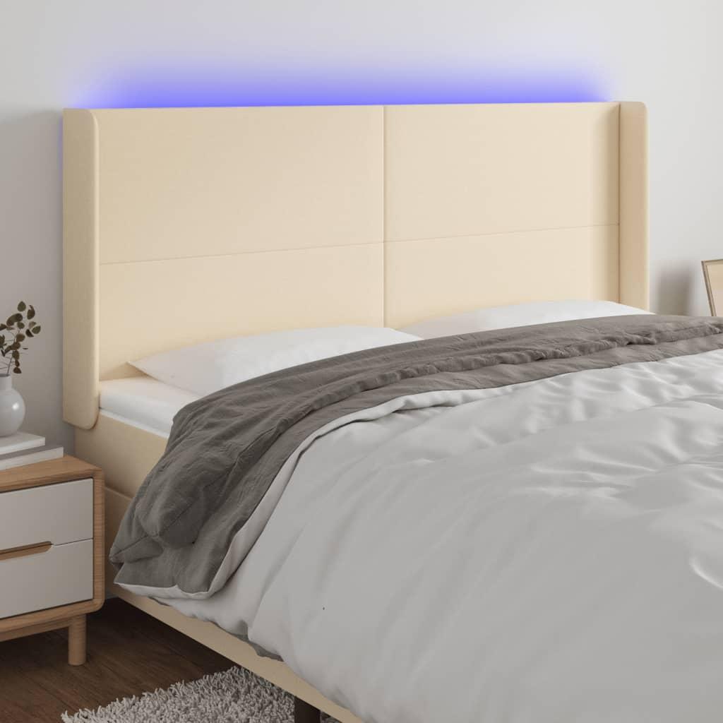 Sengegavl med LED-lys 183x16x118/128 cm stof cremefarvet billede
