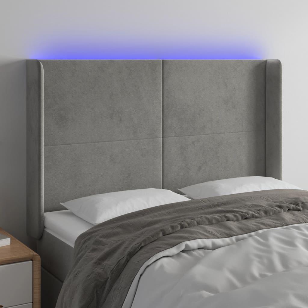 Sengegavl med LED-lys 147x16x118/128 cm fløjl lysegrå billede