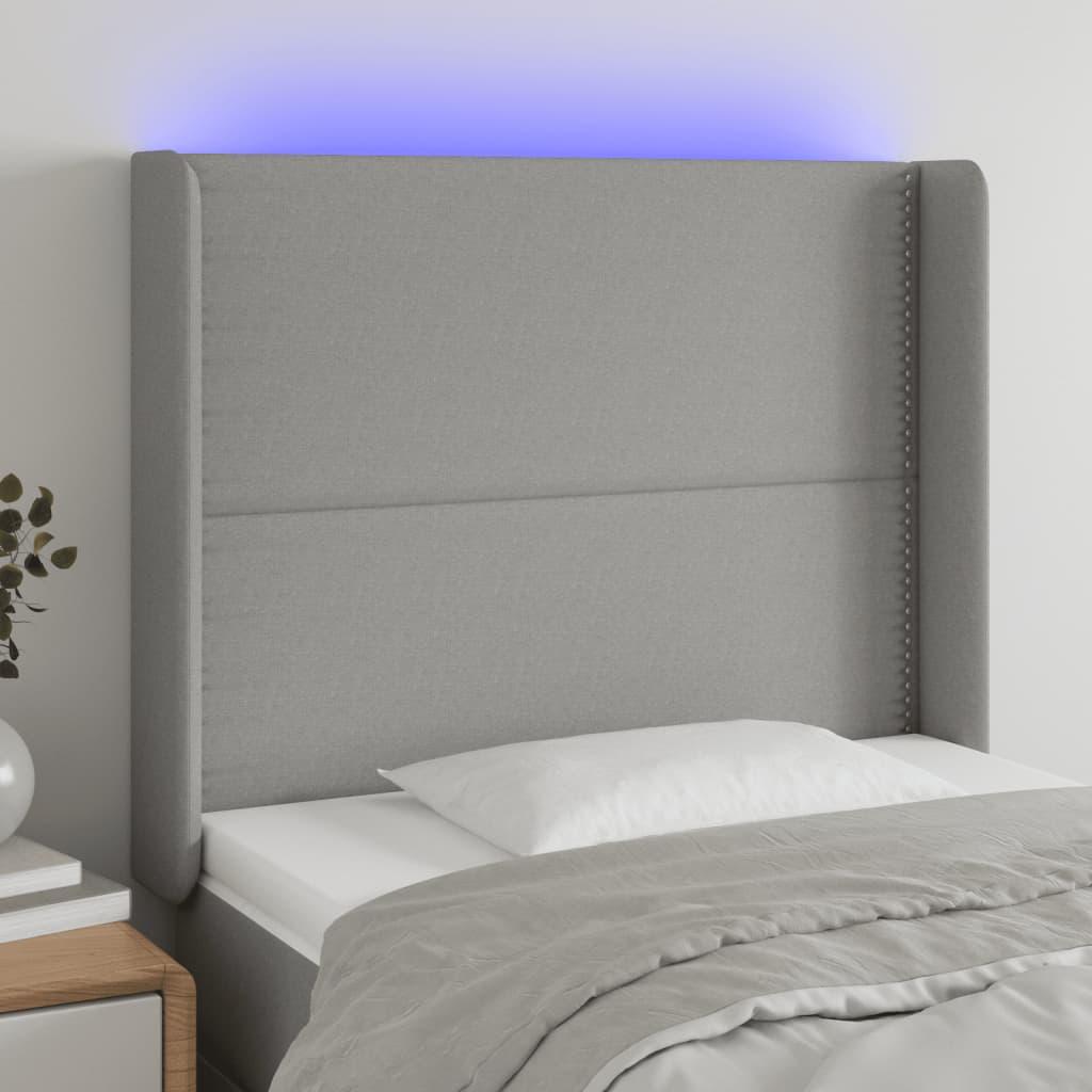 Sengegavl med LED-lys 103x16x118/128 cm stof lysegrå billede