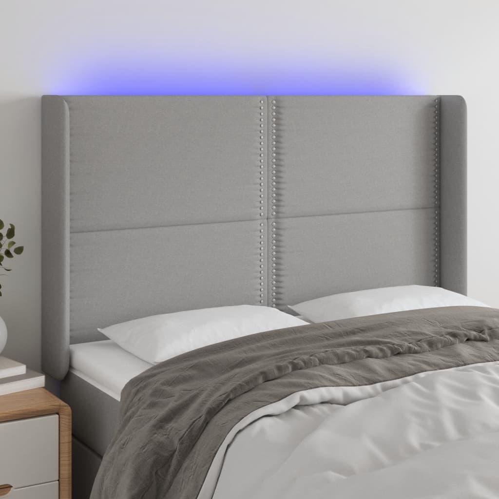 Sengegavl med LED-lys 147x16x118/128 cm stof lysegrå billede