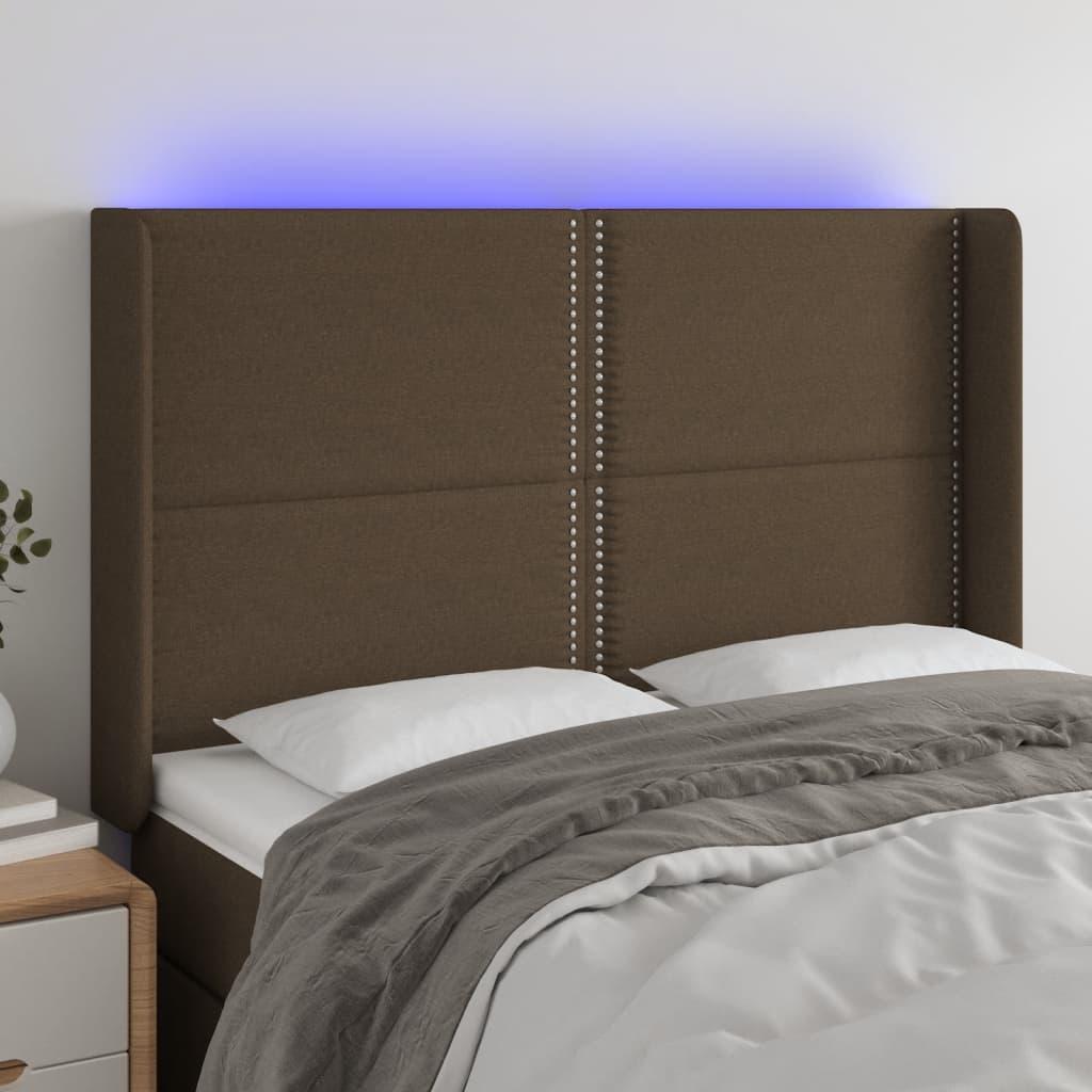 Sengegavl med LED-lys 147x16x118/128 cm stof mørkebrun billede