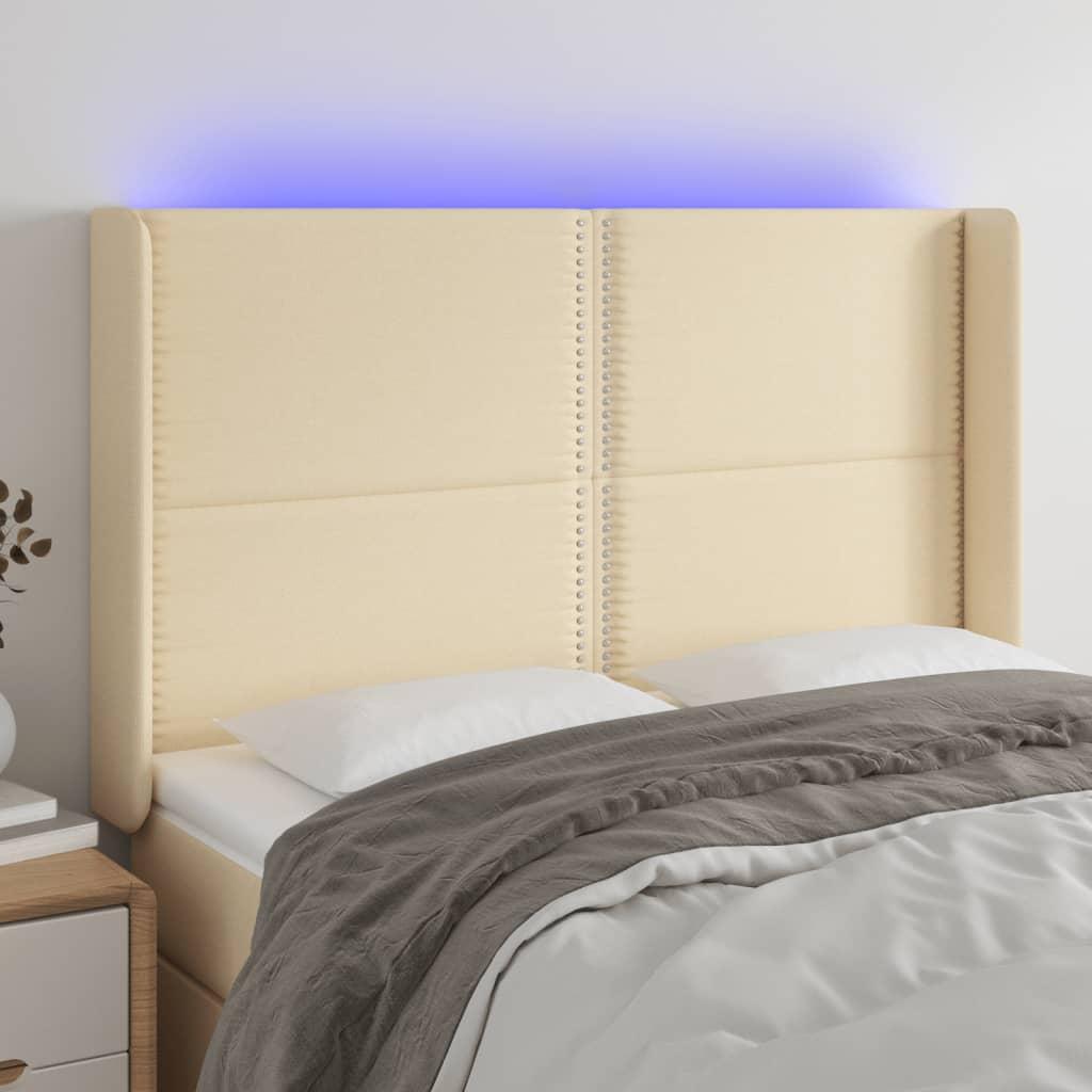 Sengegavl med LED-lys 147x16x118/128 cm stof cremefarvet billede