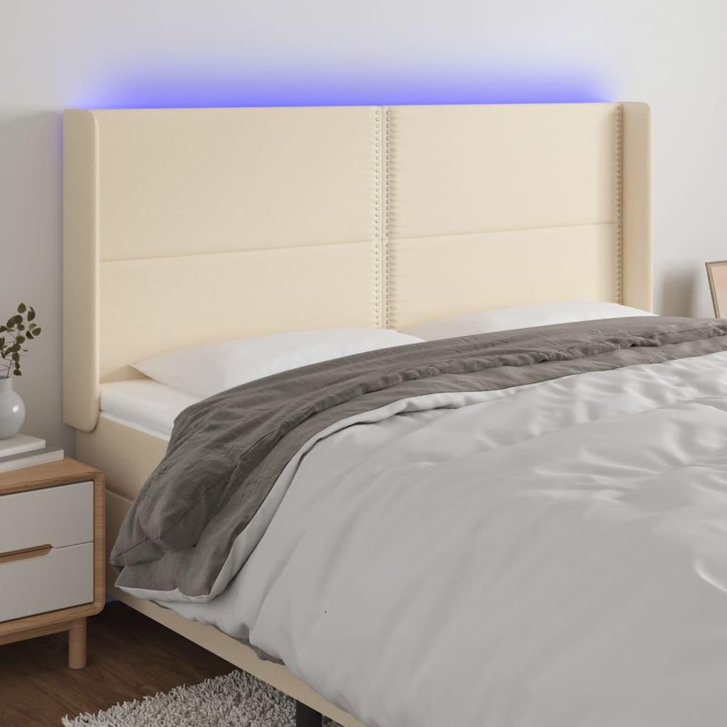 Sengegavl med LED-lys 183x16x118/128 cm stof cremefarvet billede