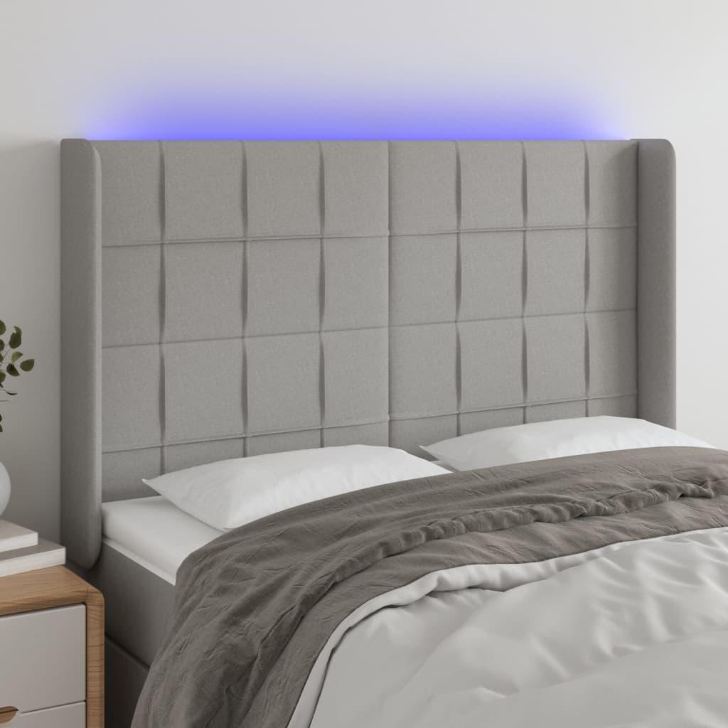 Sengegavl med LED-lys 147x16x118/128 cm stof lysegrå billede