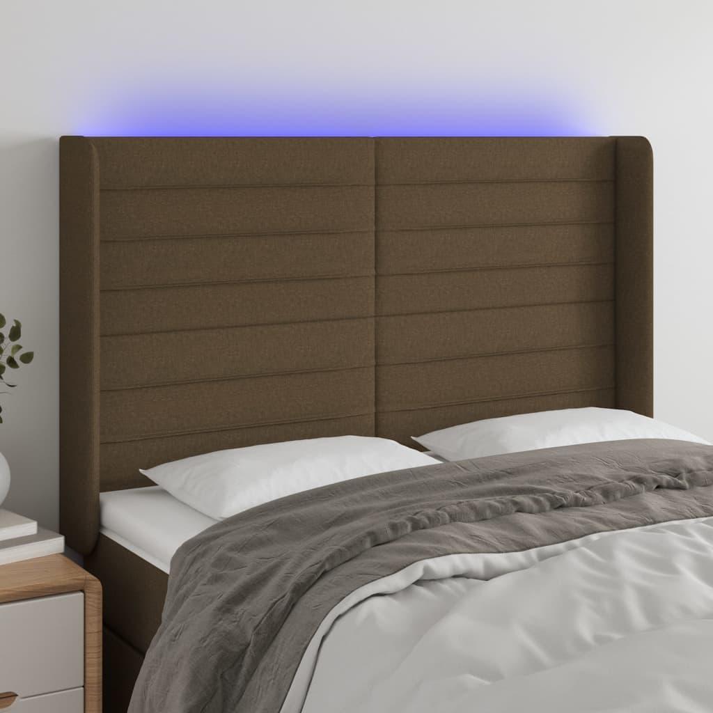 Sengegavl med LED-lys 147x16x118/128 cm stof mørkebrun billede