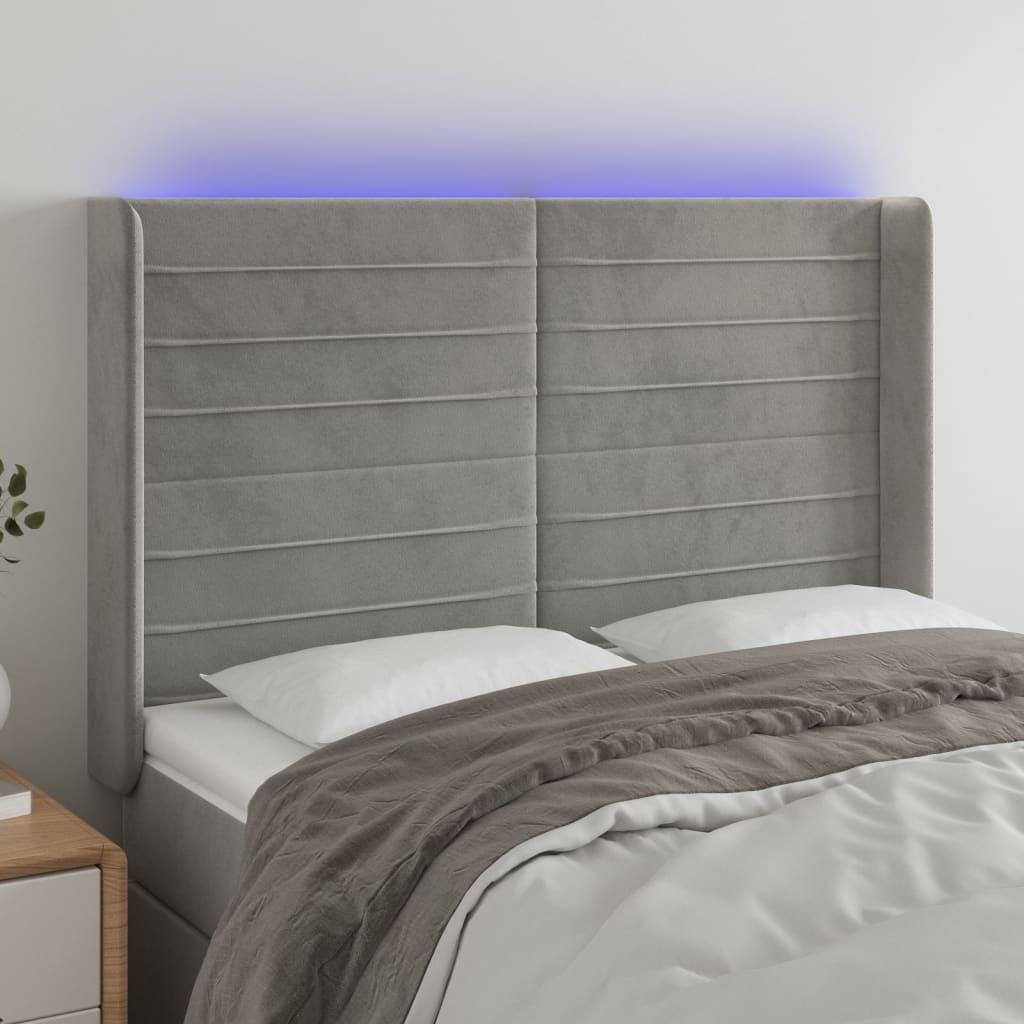 Sengegavl med LED-lys 147x16x118/128 cm fløjl lysegrå billede