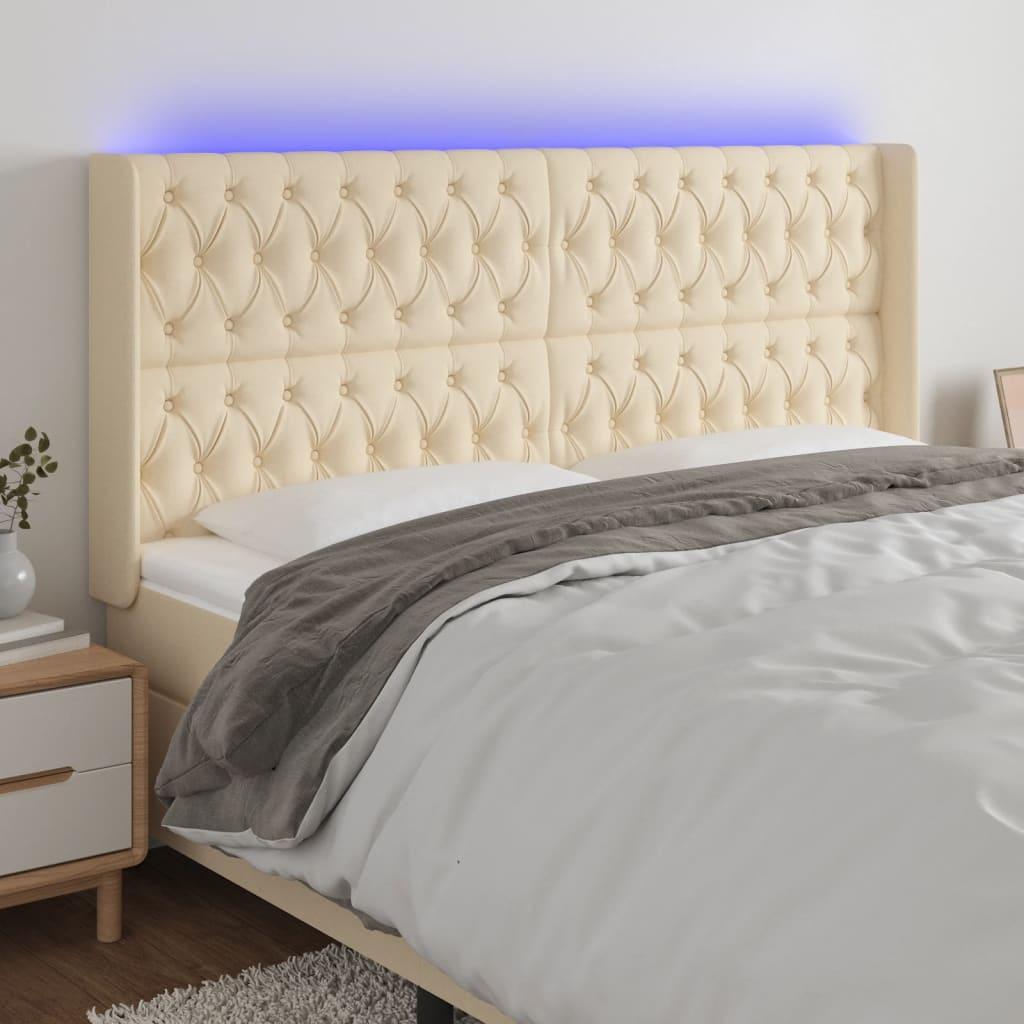 Sengegavl med LED-lys 203x16x118/128 cm stof cremefarvet billede