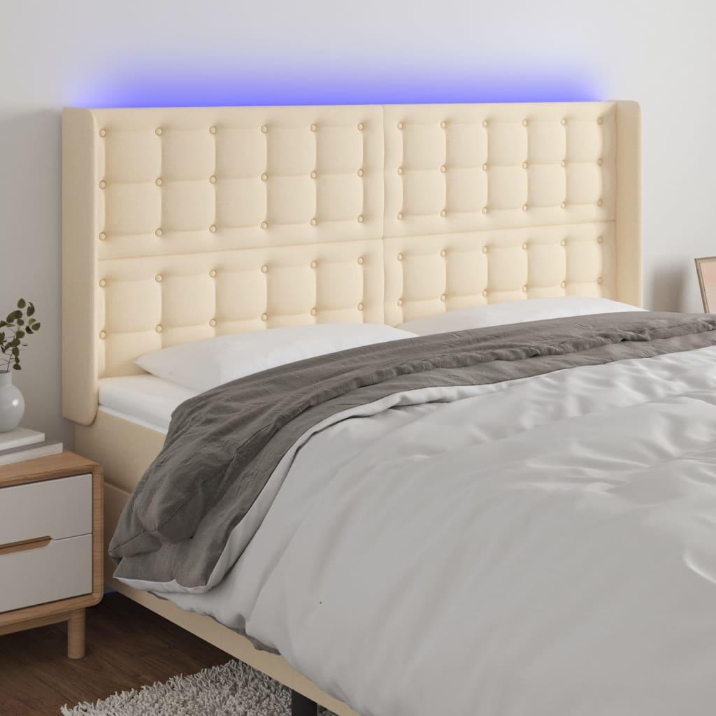 Sengegavl med LED-lys 163x16x118/128 cm stof cremefarvet billede