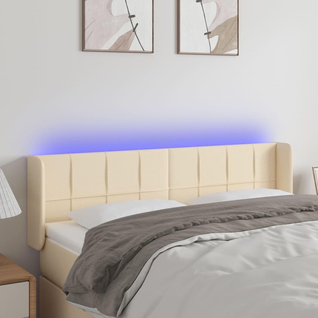 Sengegavl med LED-lys 147x16x78/88 cm stof cremefarvet billede