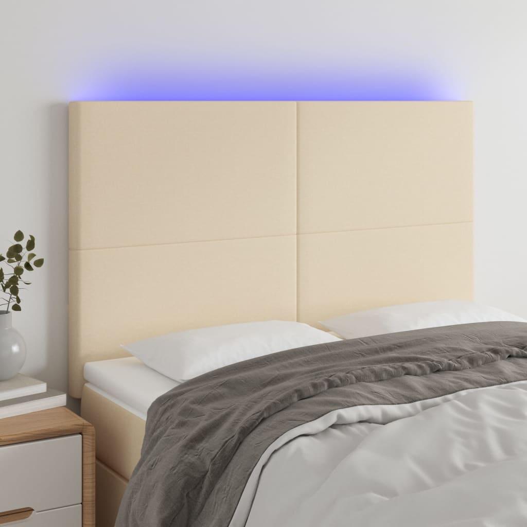Sengegavl med LED-lys 144x5x118/128 cm stof cremefarvet billede