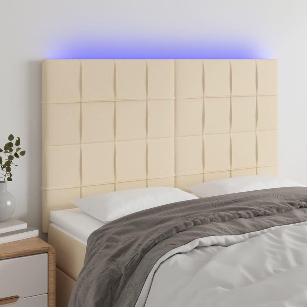 Sengegavl med LED-lys 144x5x118/128 cm stof cremefarvet billede