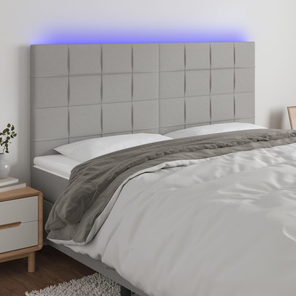 Sengegavl med LED-lys 160x5x118/128 cm stof lysegrå billede
