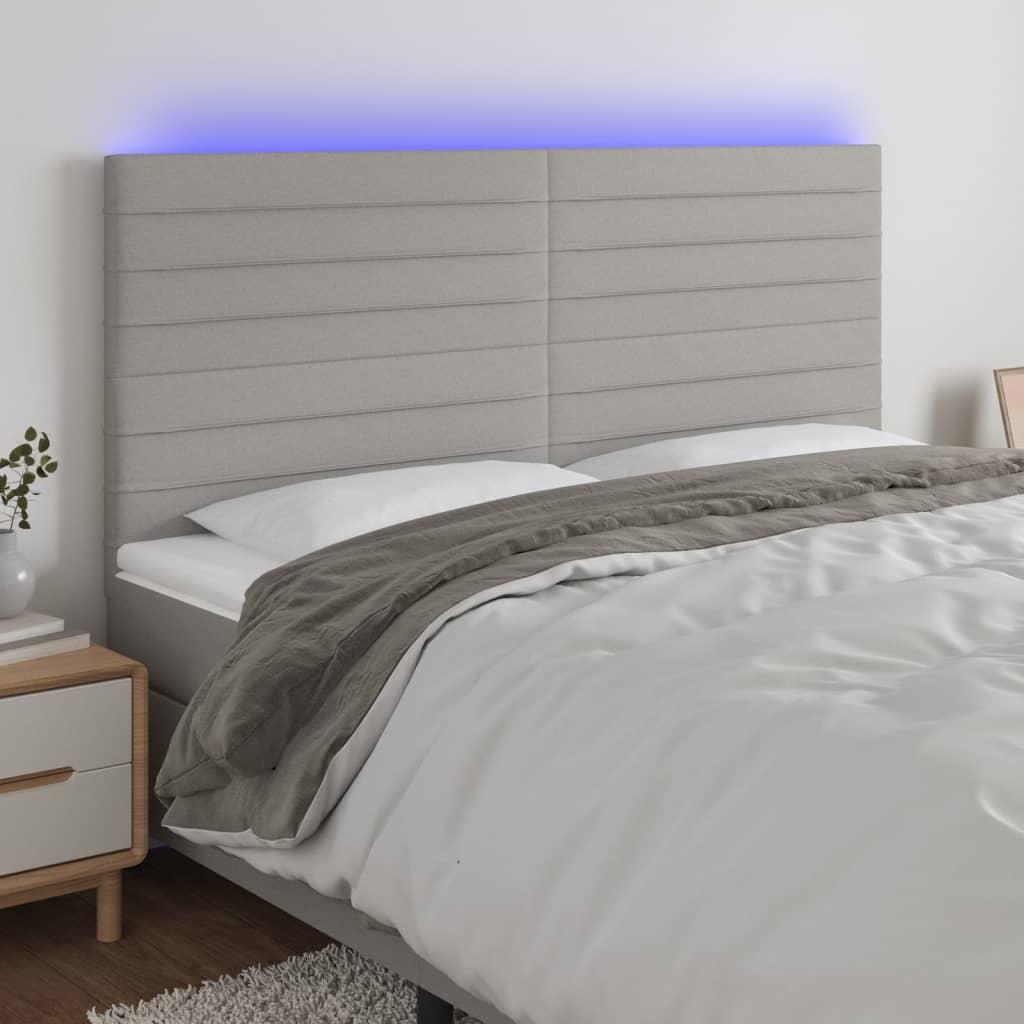 Sengegavl med LED-lys 160x5x118/128 cm stof lysegrå billede