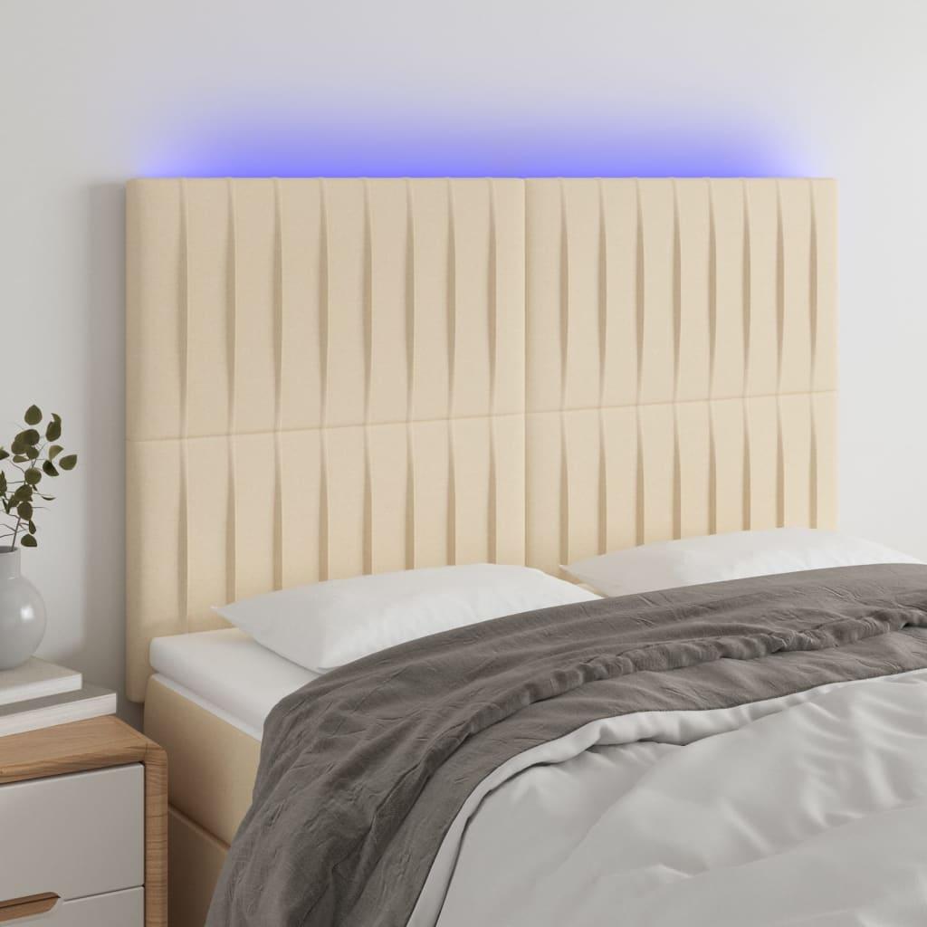 Sengegavl med LED-lys 144x5x118/128 cm stof cremefarvet billede