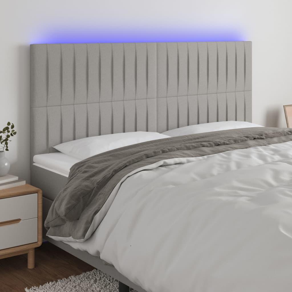 Sengegavl med LED-lys 180x5x118/128 cm stof lysegrå billede