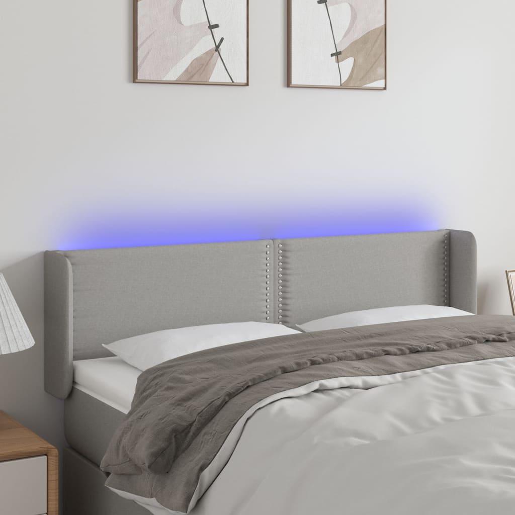 Sengegavl med LED-lys 147x16x78/88 cm stof lysegrå billede