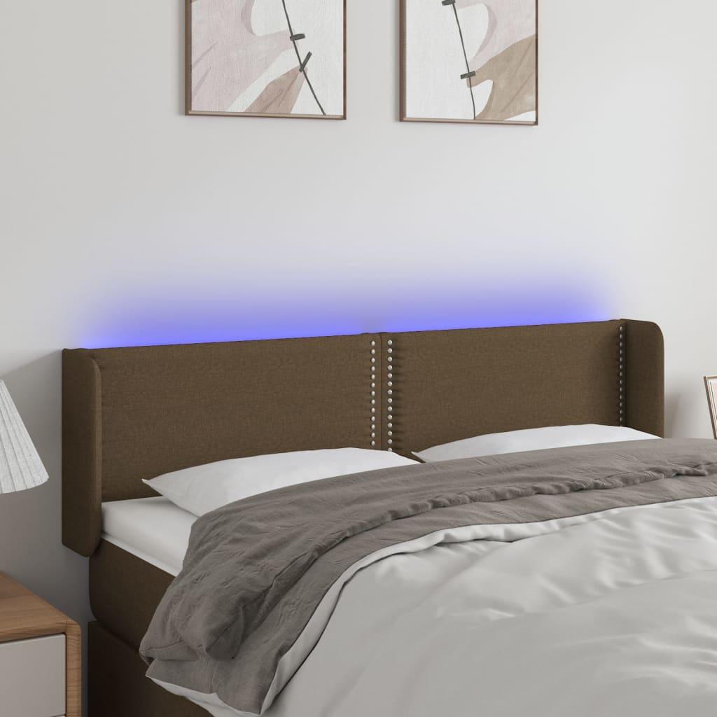 Sengegavl med LED-lys 147x16x78/88 cm stof mørkebrun billede