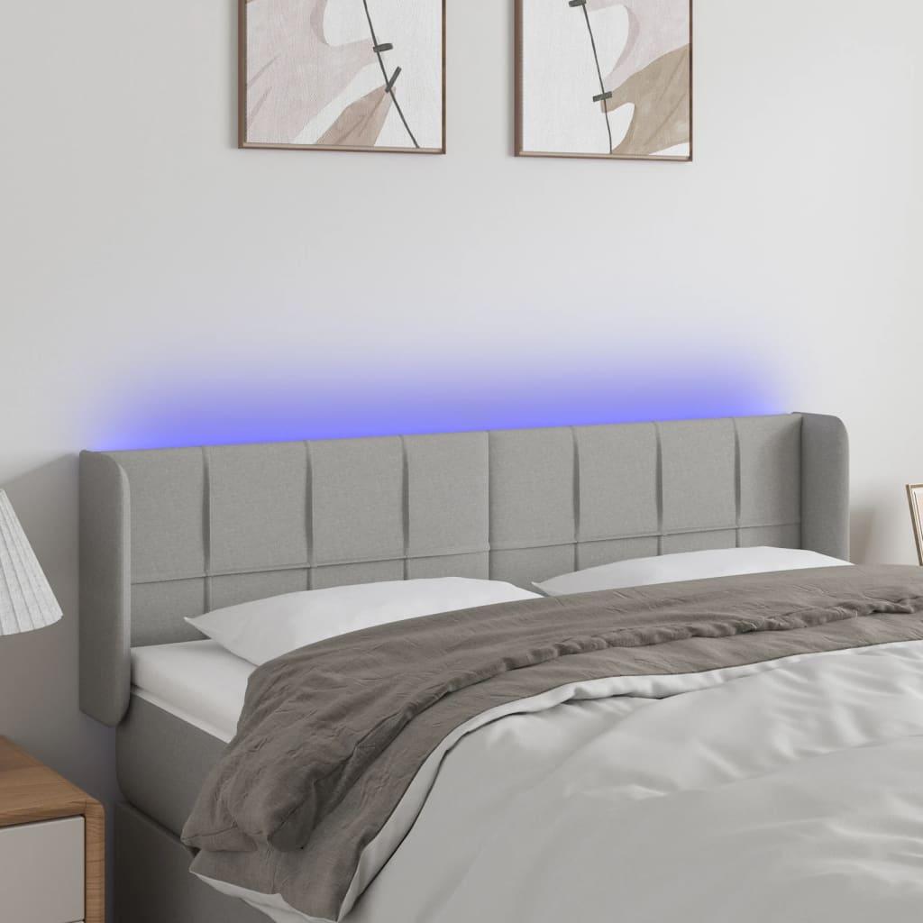 Sengegavl med LED-lys 147x16x78/88 cm stof lysegrå billede