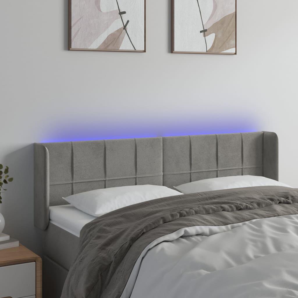Sengegavl med LED-lys 147x16x78/88 cm fløjl lysegrå billede
