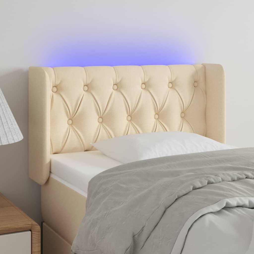 Sengegavl med LED-lys 83x16x78/88 cm stof cremefarvet billede