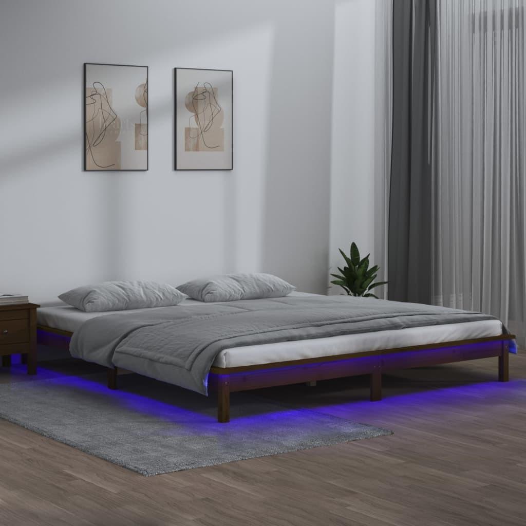 Sengeramme med LED-lys 140x190 cm massivt træ gyldenbrun billede